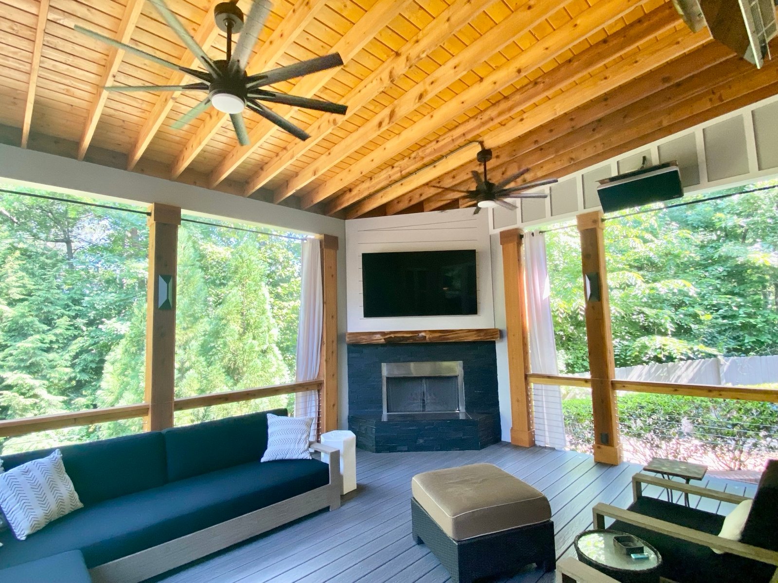 Screened porch with cedar ceiling and stone fireplace built by GHIR Construction in Cumming, Georgia