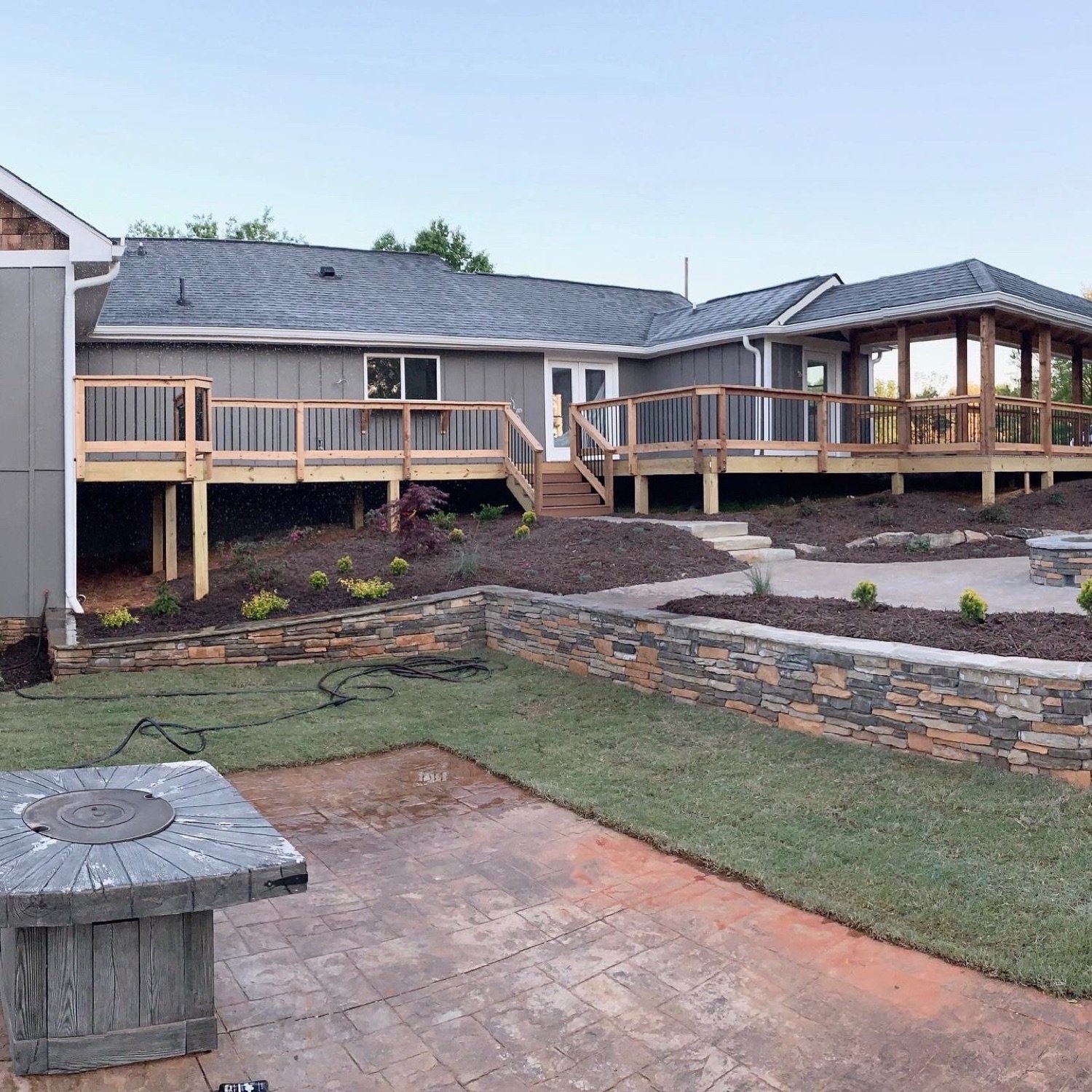 Rear exterior of a home addition in Cumming, GA showing the new footprint and deck, Sneddon Project by GHIR Construction