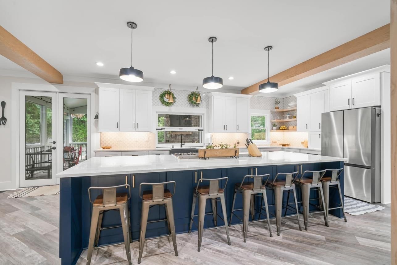 Open-concept kitchen remodel with navy island and pendant lighting in Alpharetta, GA